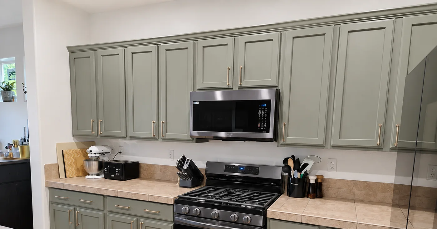 Muted green kitchen cabinet refinishing by Riversons Painting