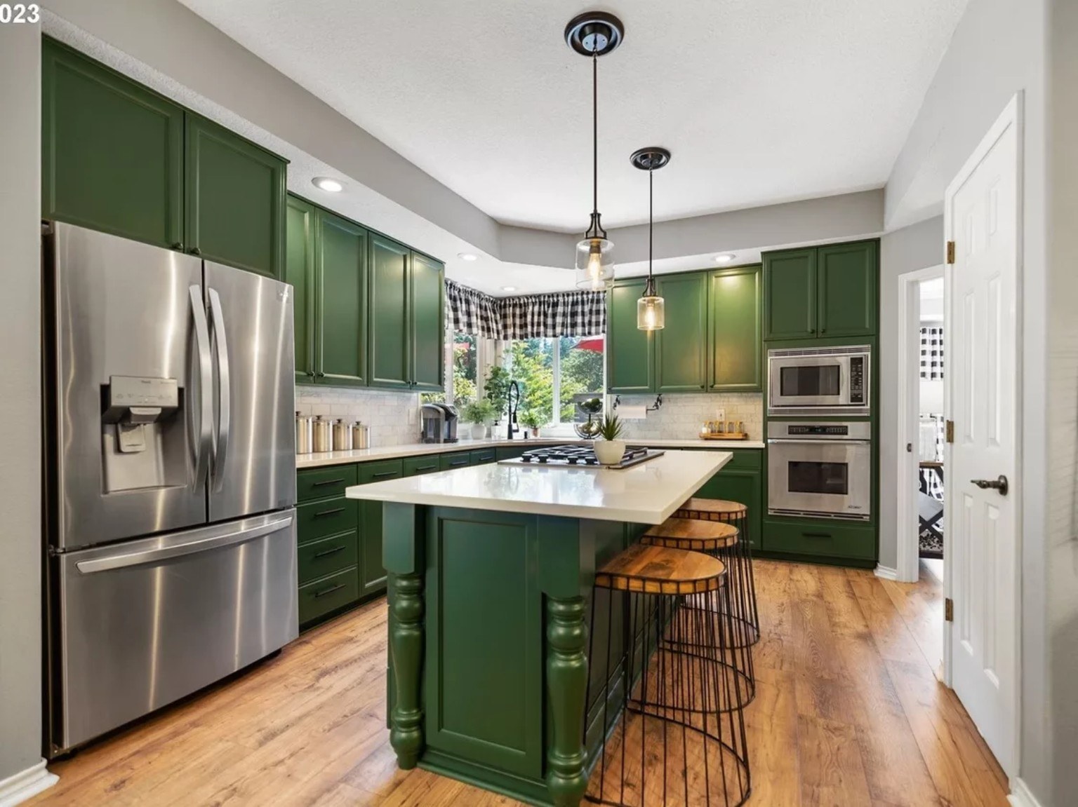 Professionally refinished kitchen cabinets by Riversons Painting