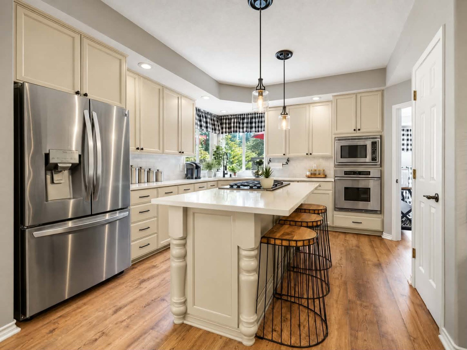 Professionally refinished kitchen cabinets by Riversons Painting