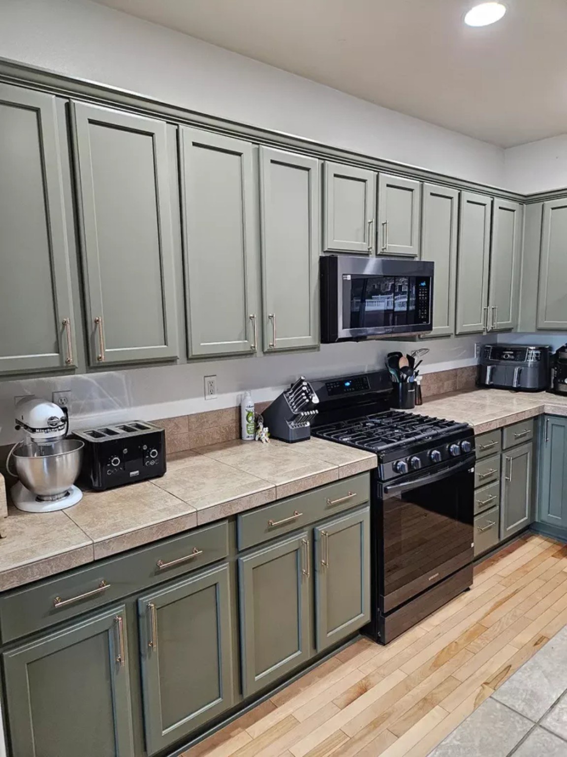 Professionally refinished kitchen cabinets by Riversons Painting