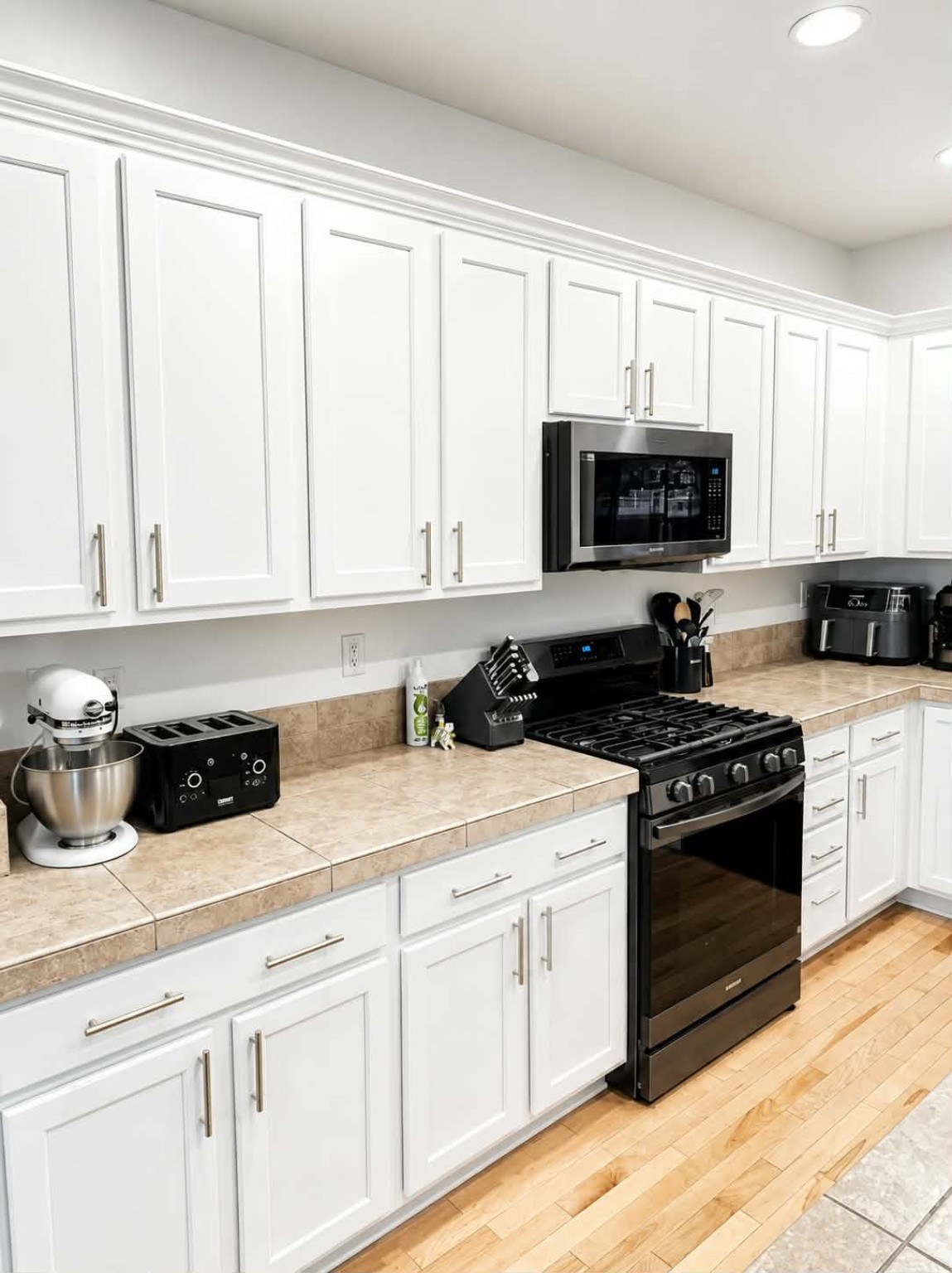 Professionally refinished kitchen cabinets by Riversons Painting