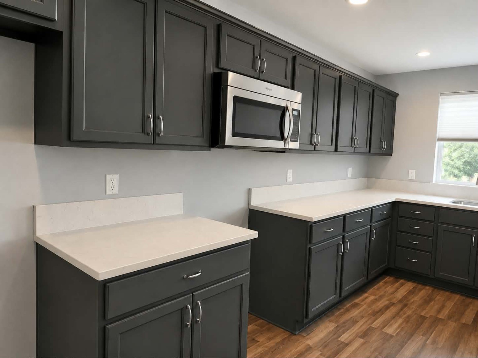 Professionally refinished kitchen cabinets by Riversons Painting